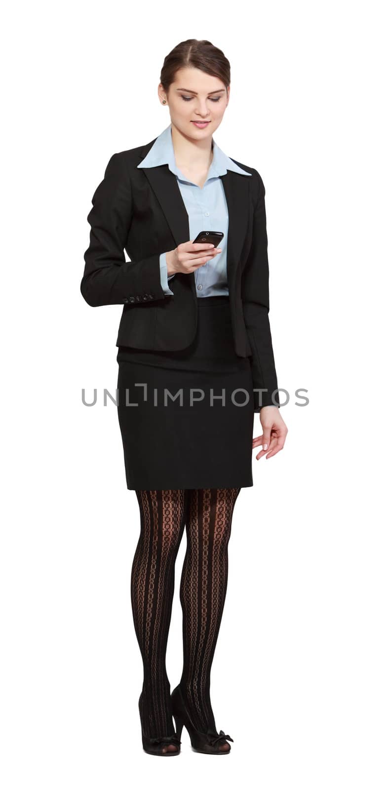 Young businesswoman checking her mobile phone, isolated against a white background.