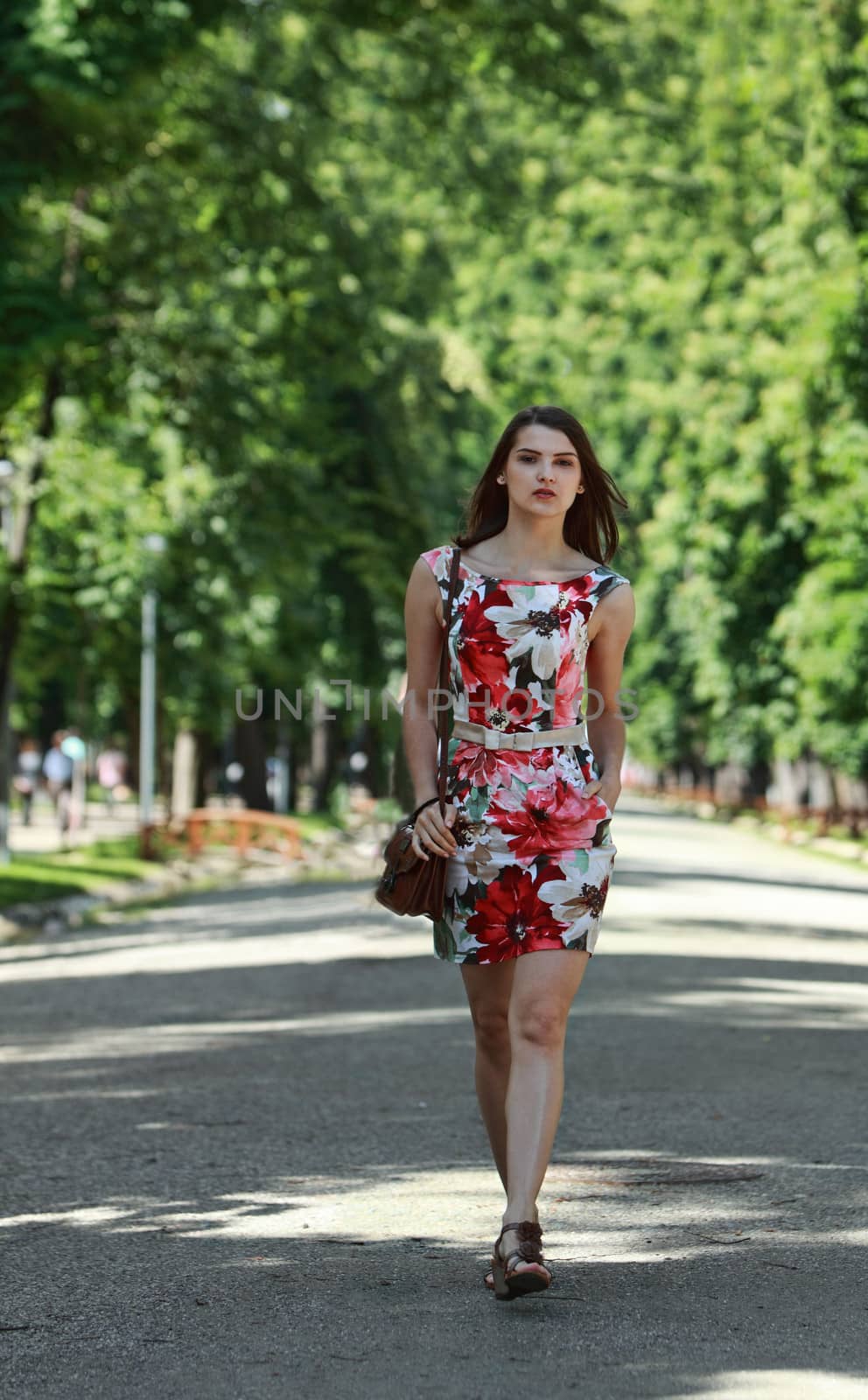 Young Woman Walking in a Park by RazvanPhotography