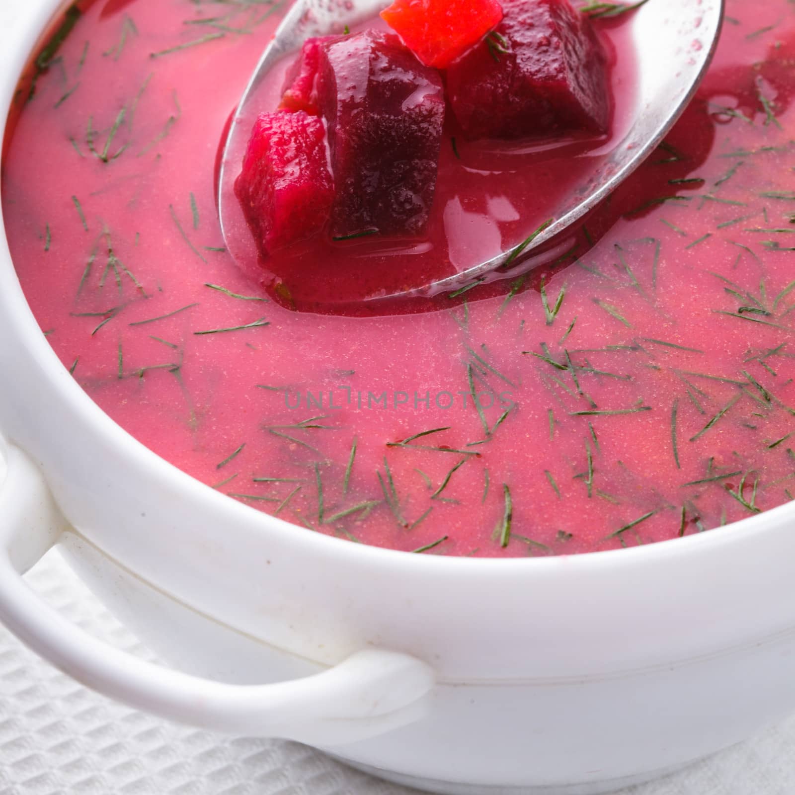 Beetroot soup in the white bowl close up