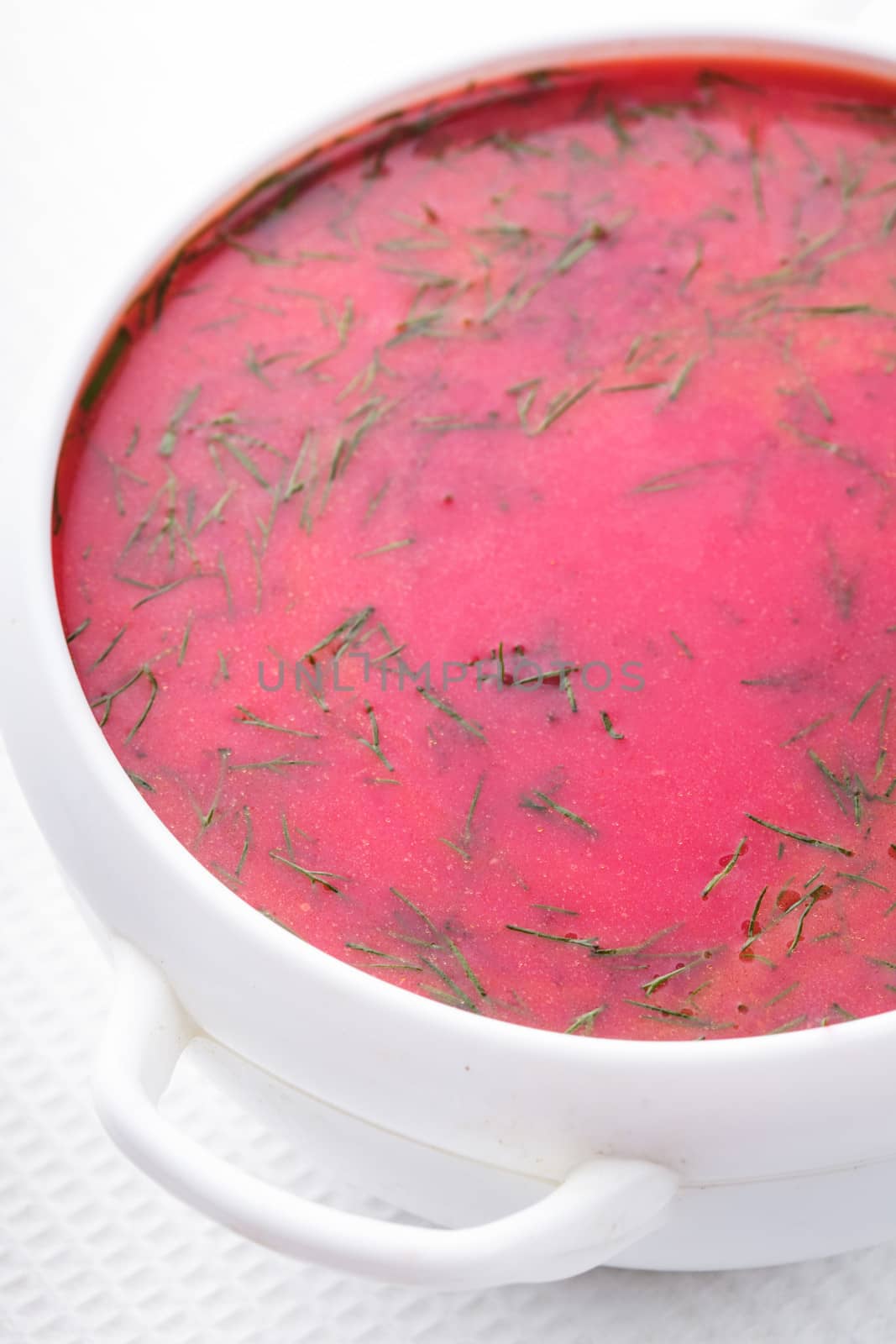 Beetroot soup in the white bowl close up