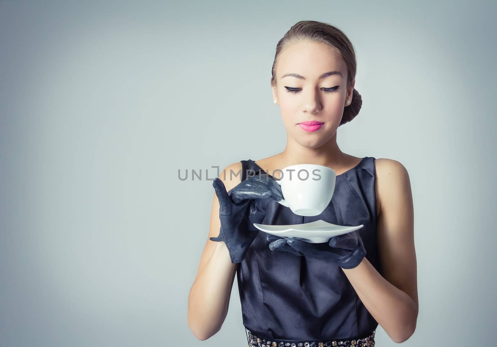 Fashion portrait of beautiful young girl with a coffee cup in classic vintage style