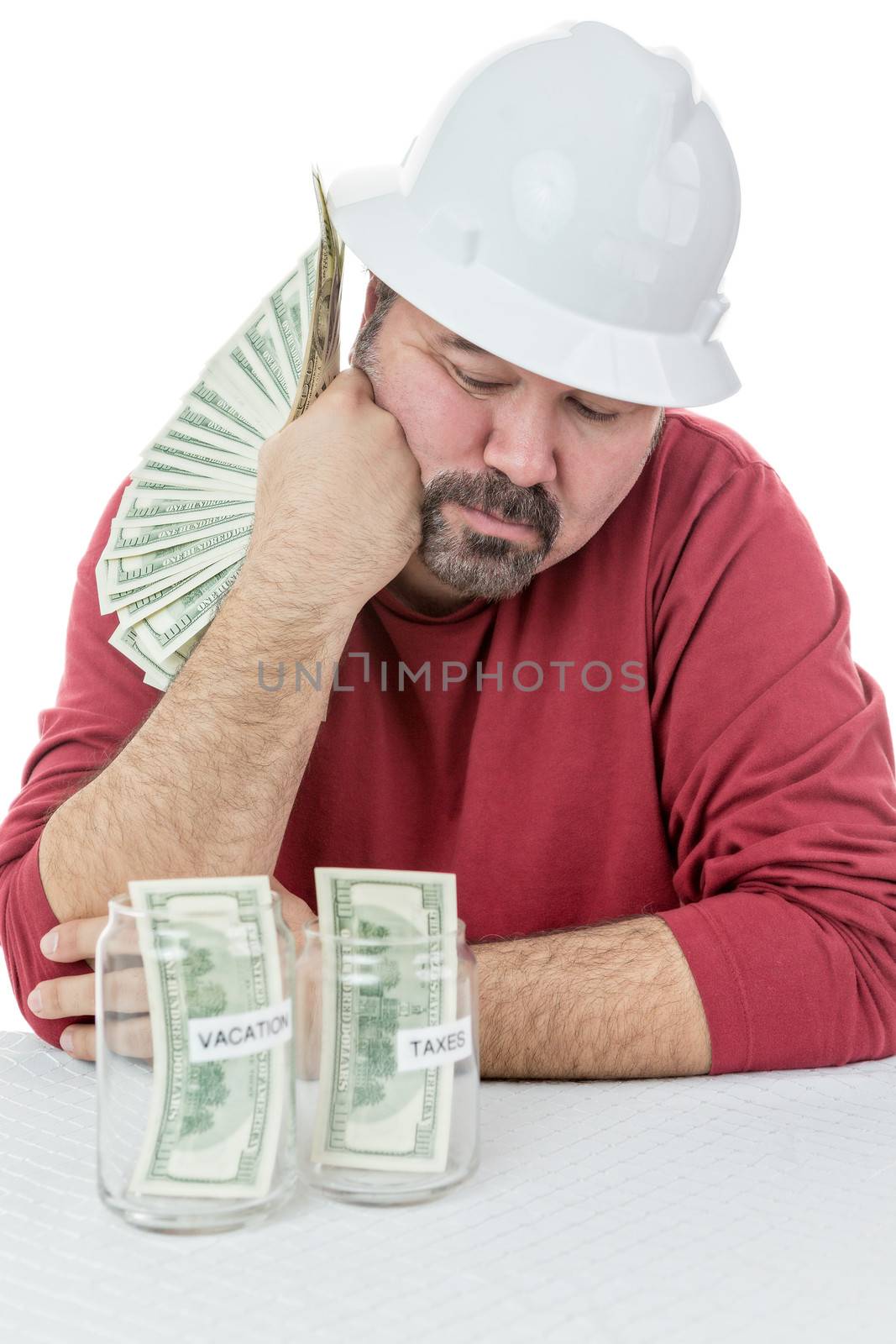 Depressed construction worker deciding how to split money between vacations and the tax obligations