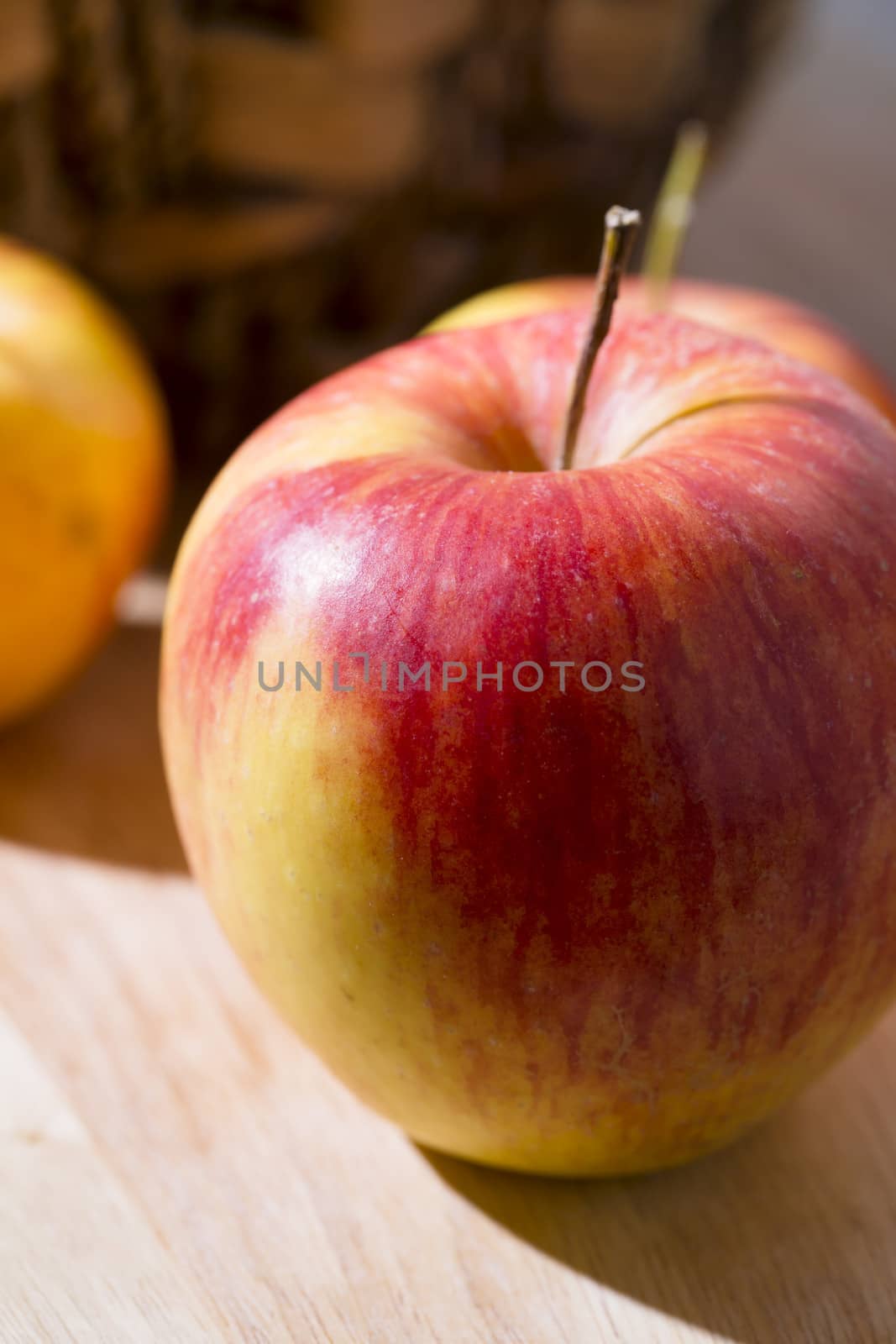 Fresh red and yellow apple in strong light.
