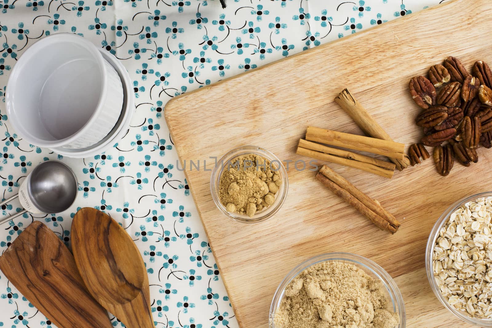 Cinnamon sticks , pecans and other spices on cutting board viewed from directly above.