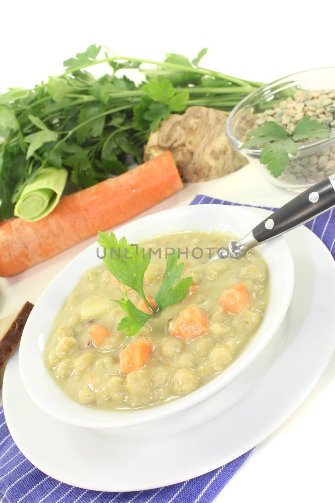 pea stew with bread and parsley on a light background