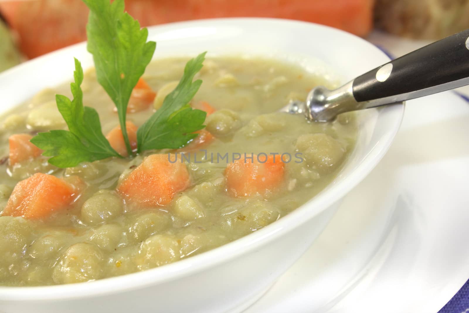 pea stew with carrots and parsley on a light background