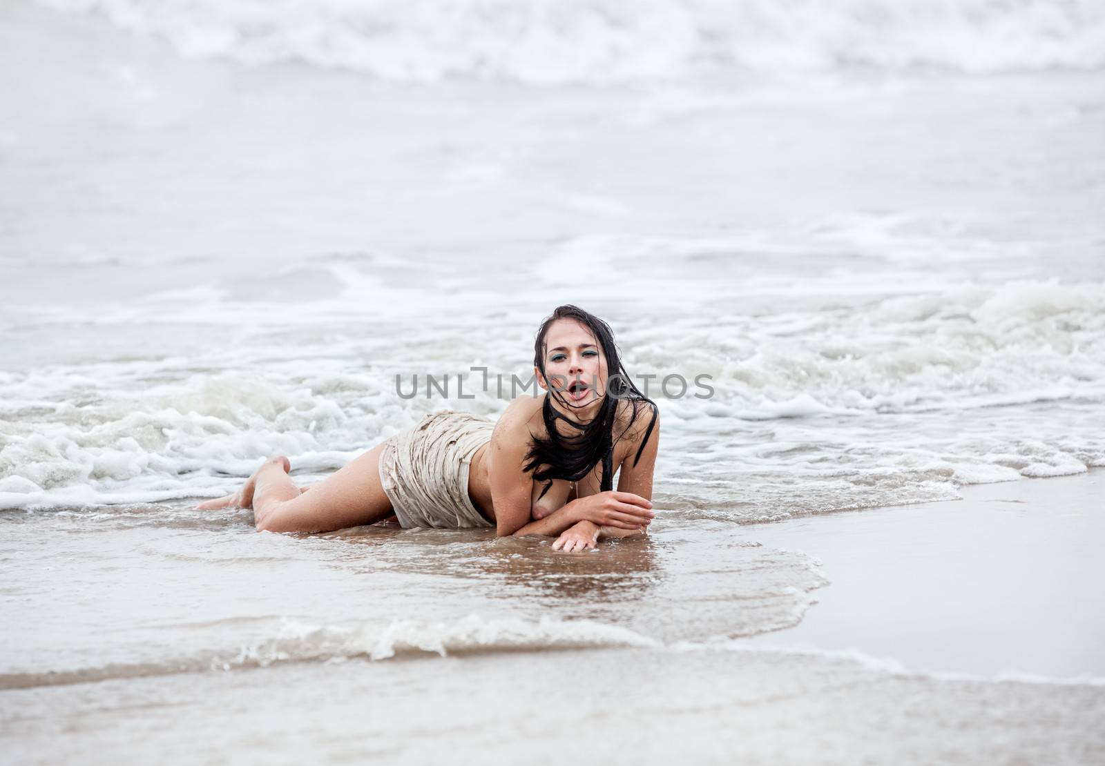 seminude woman in the cold sea waves by palinchak