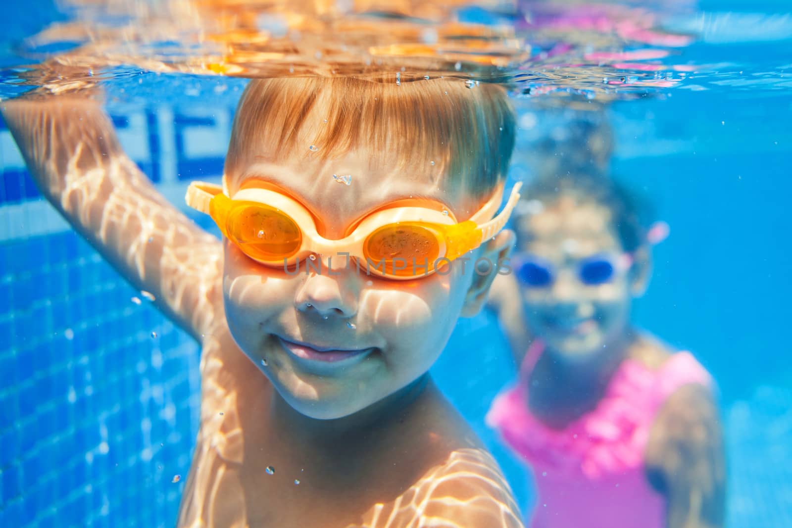 Close-up underwater portrait of the cute smiling boy