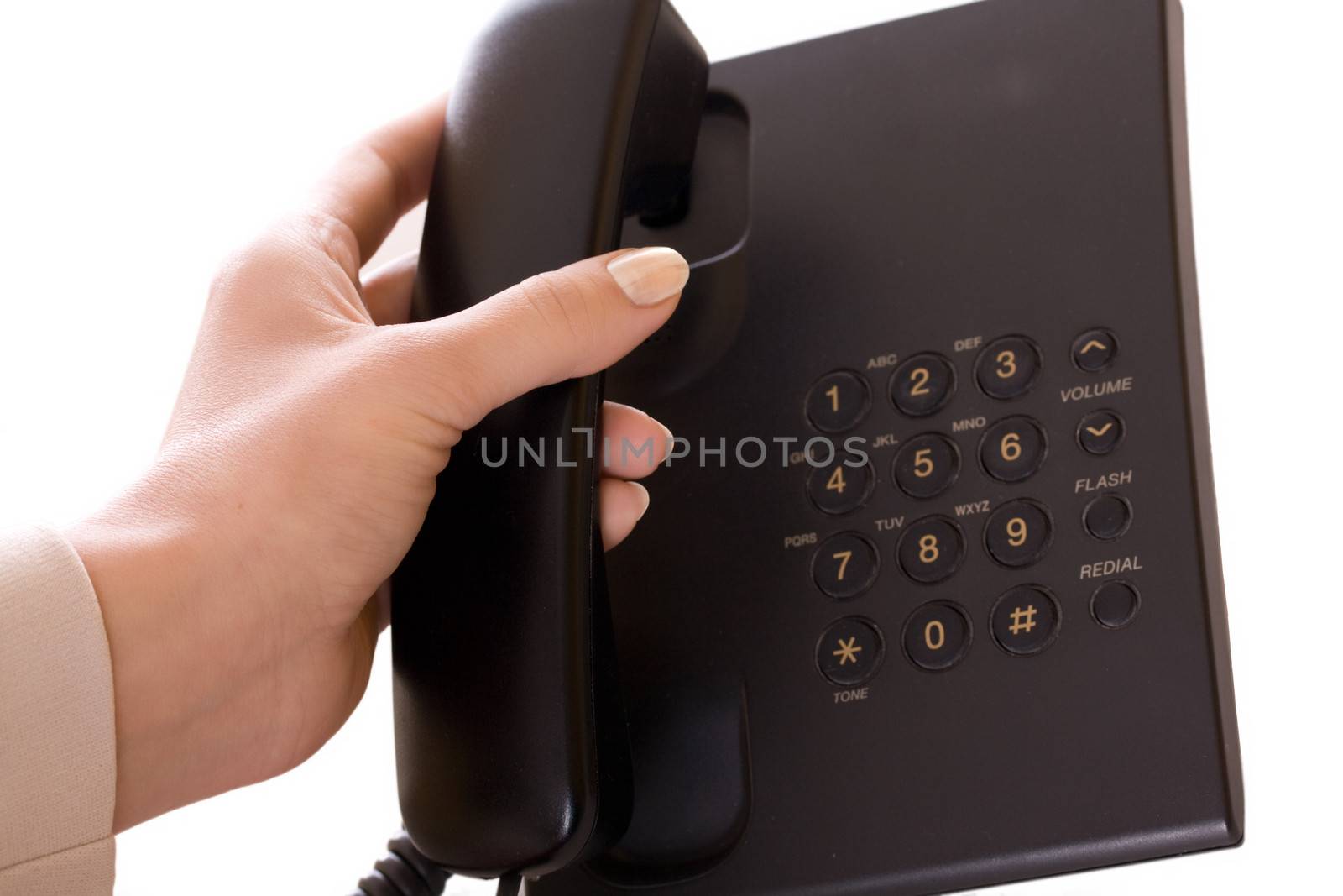 Dialing on office telephone isolated on white.