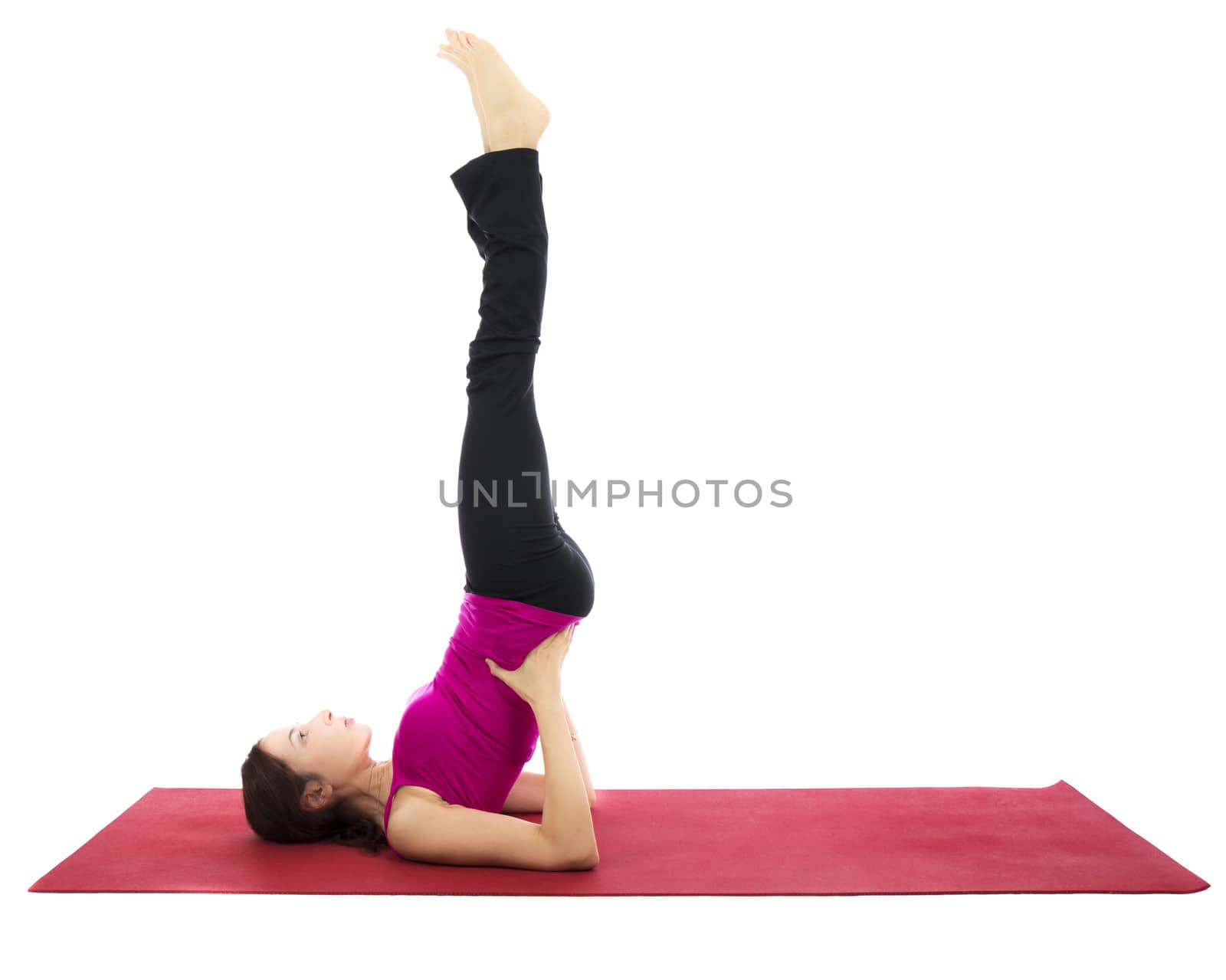 Woman doing Supported Shoulder Stand during Yoga or Pilates (Series with the same model available)