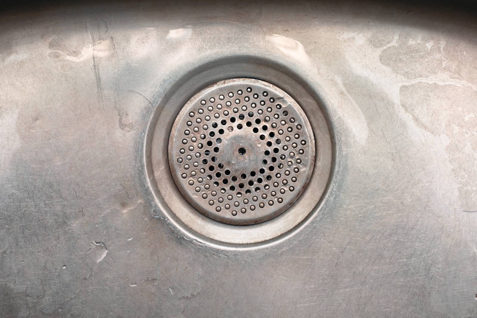 A drainage hole in a metal sink