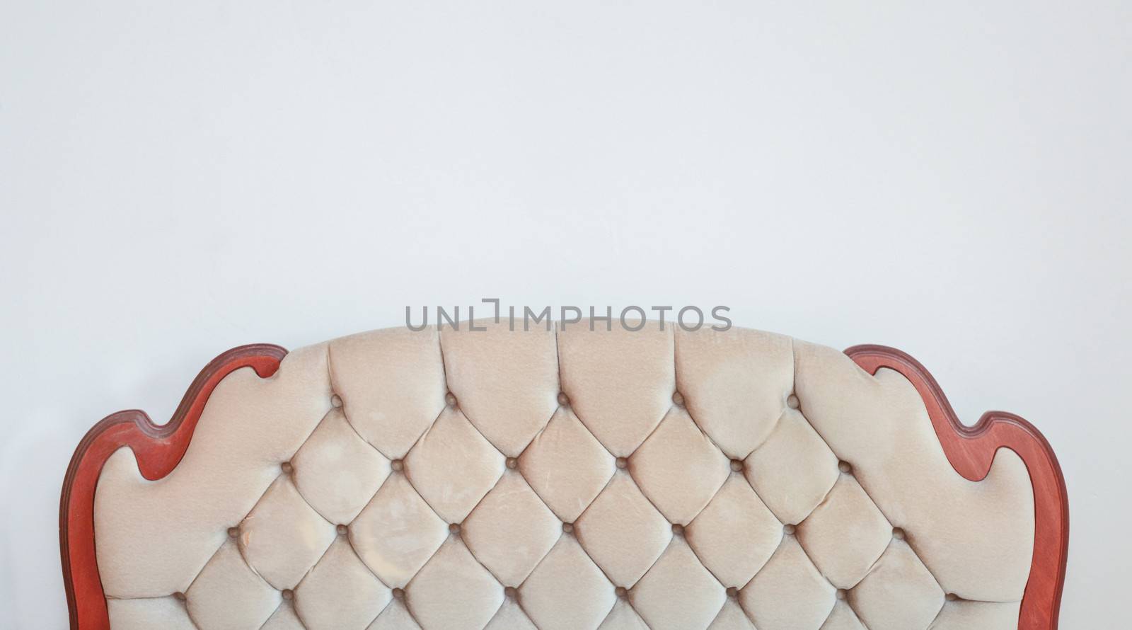 A retro bedstead against a white wall