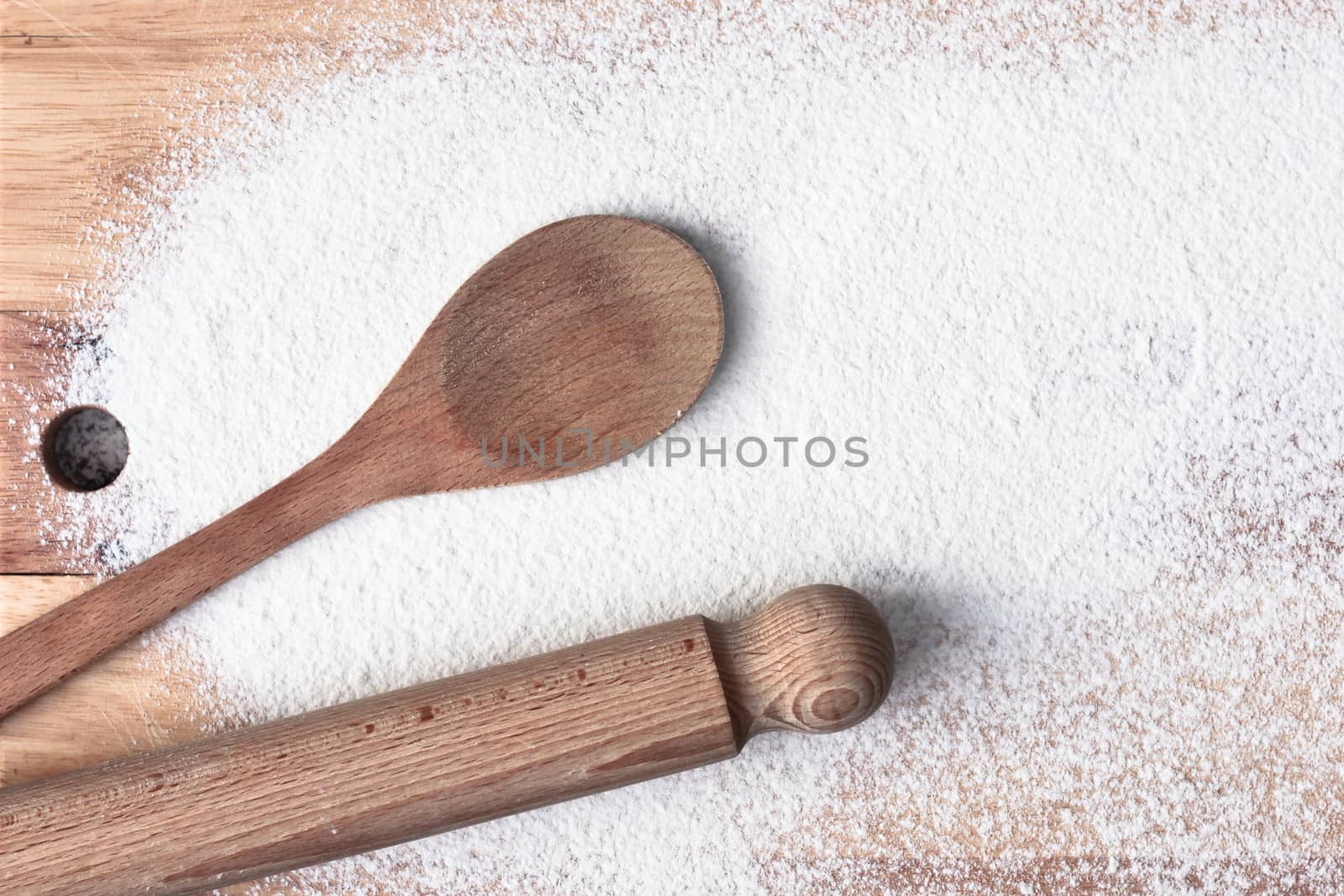 Baking items and flour on a wooden surface