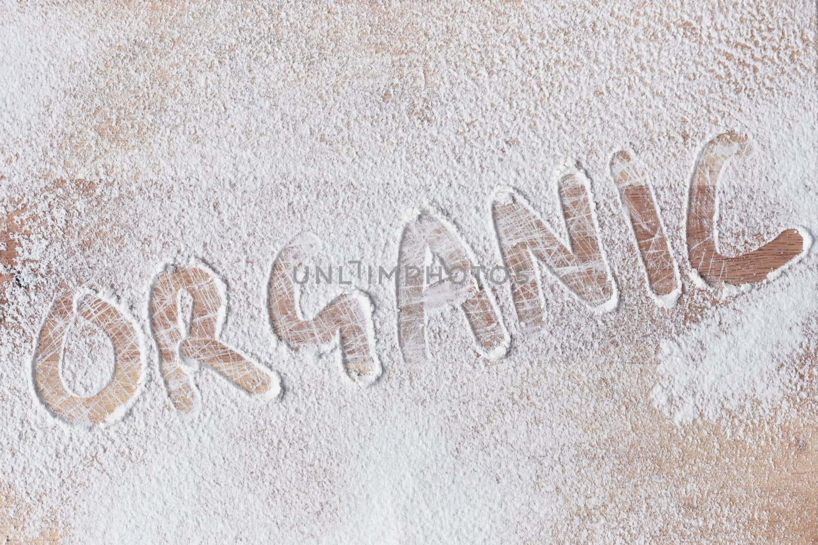 Organic written in flour on a wooden surface