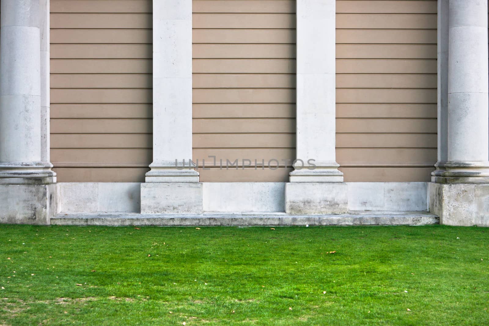 Pillars against a stone wall as a background