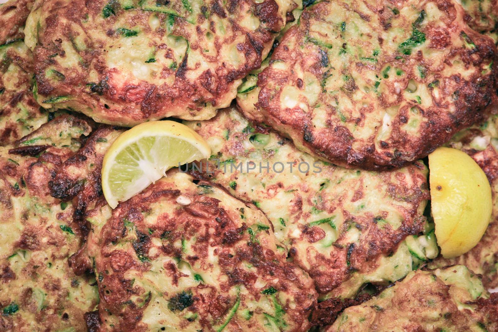 Freshly made courgette fritterswith lemon slices