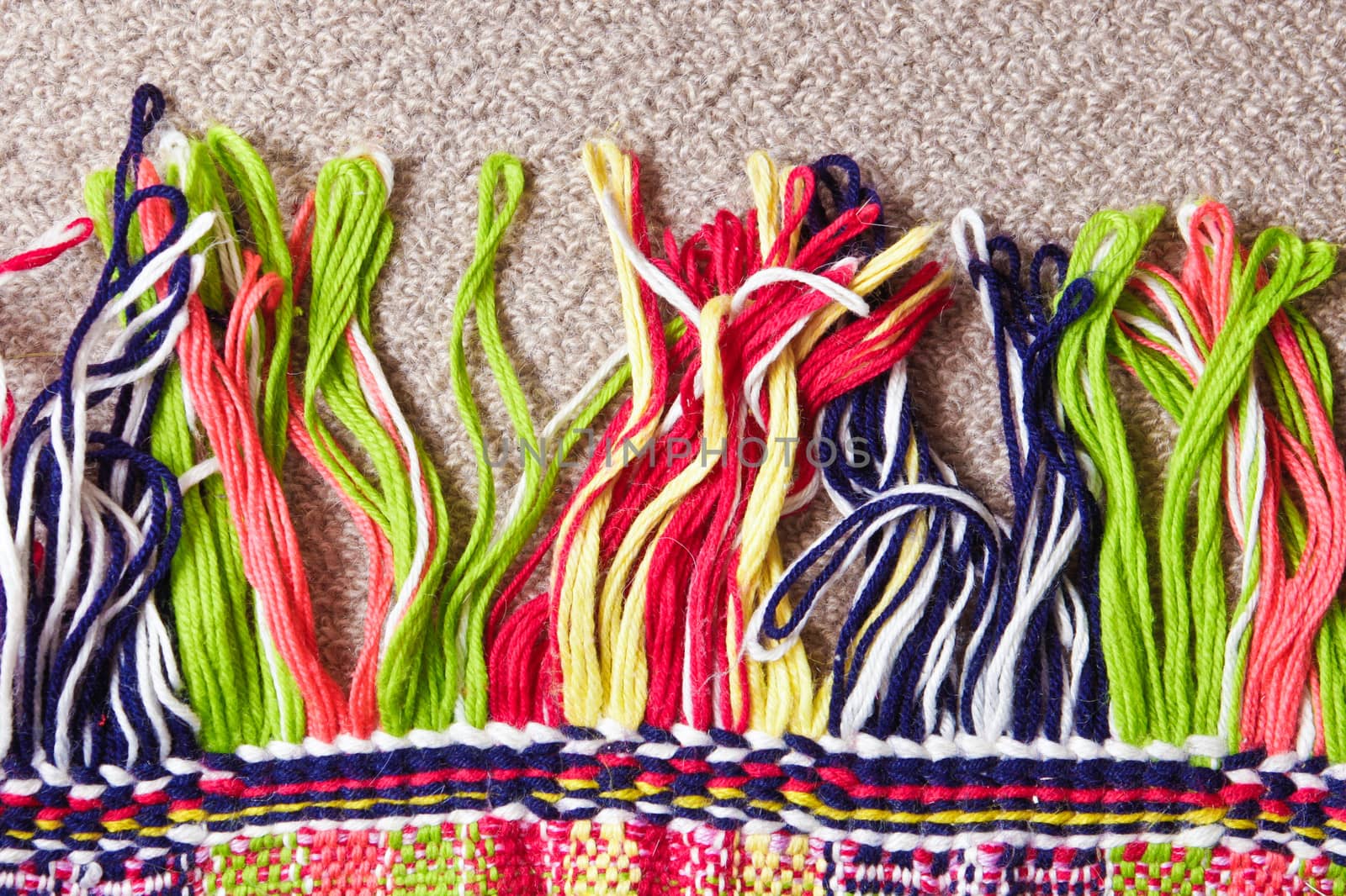 Tassles at the edge of a colorful carpet