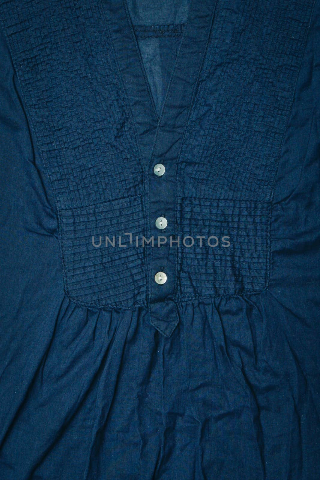 Close up of the buttons of a dark blue ladies' top