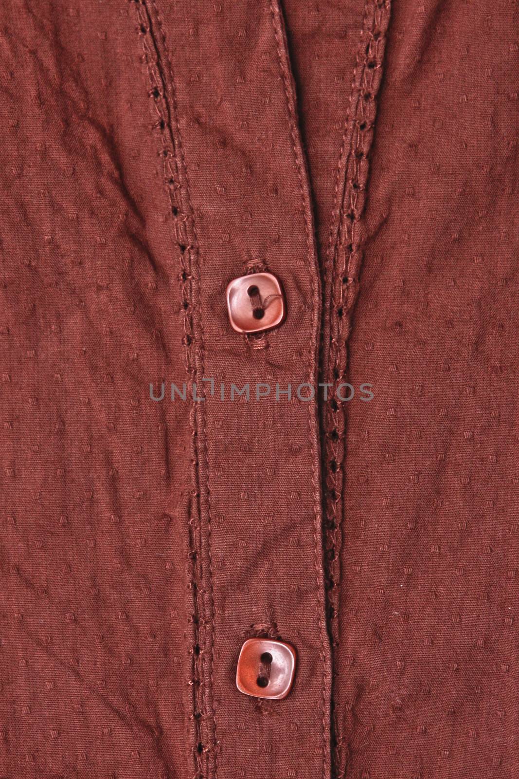 Close up of the buttons of a brown ladies' top