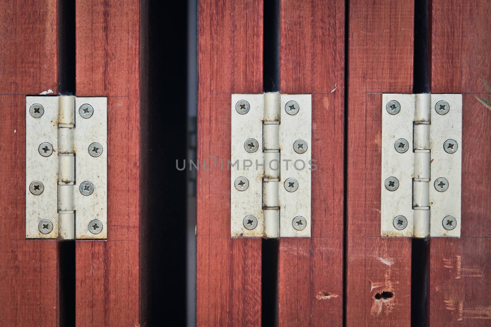 Metal hinges in wooden door panels as a background