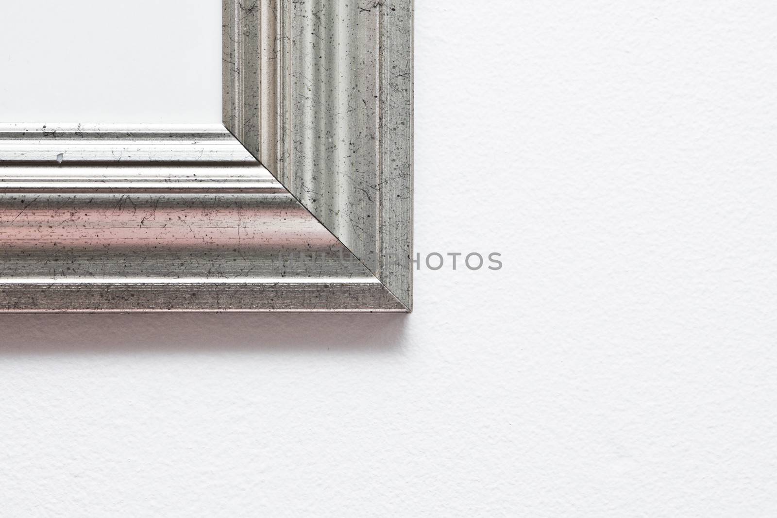 Corner of a picture frame on a white wall