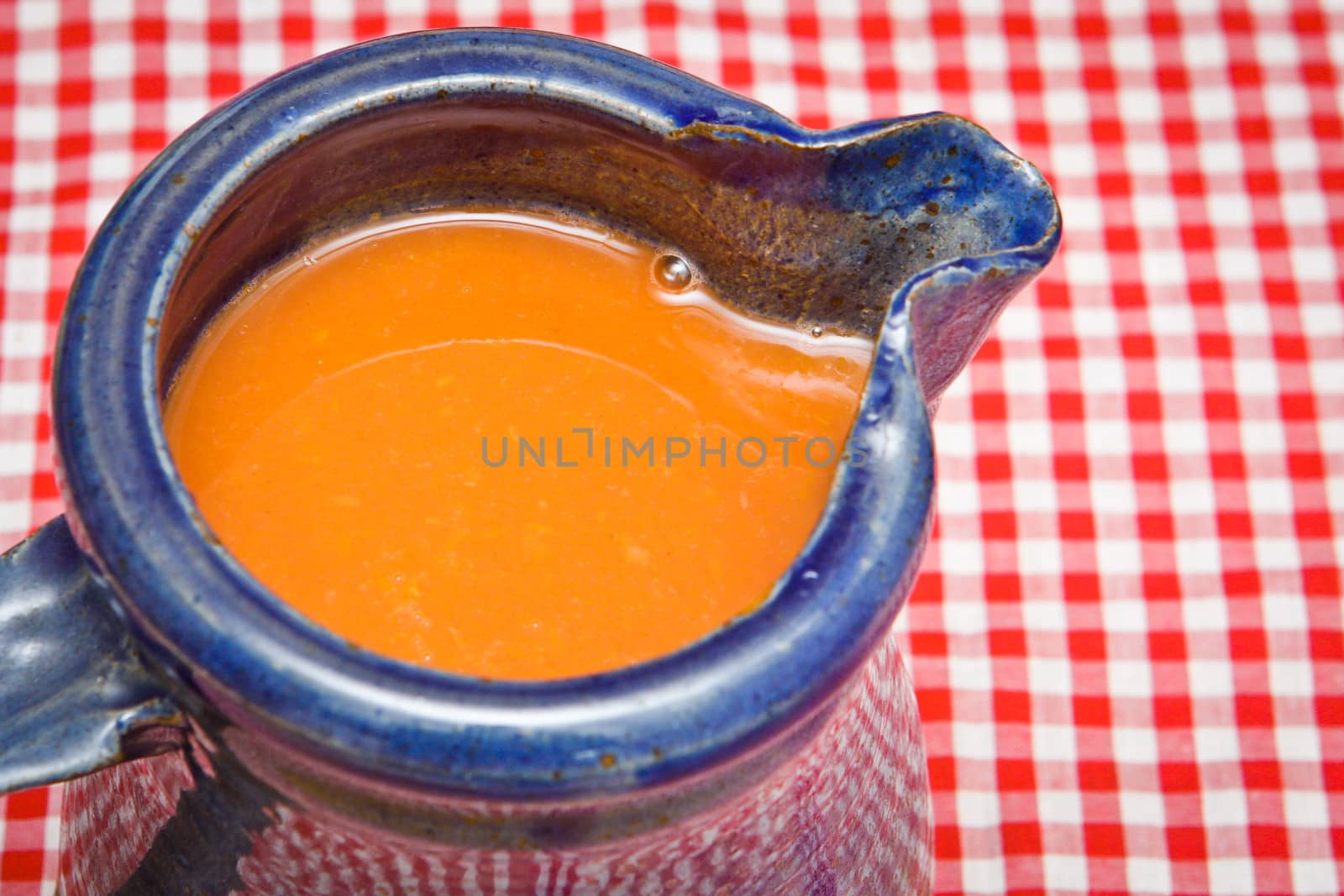 Freshly squeezed carrot juice in a blue jug