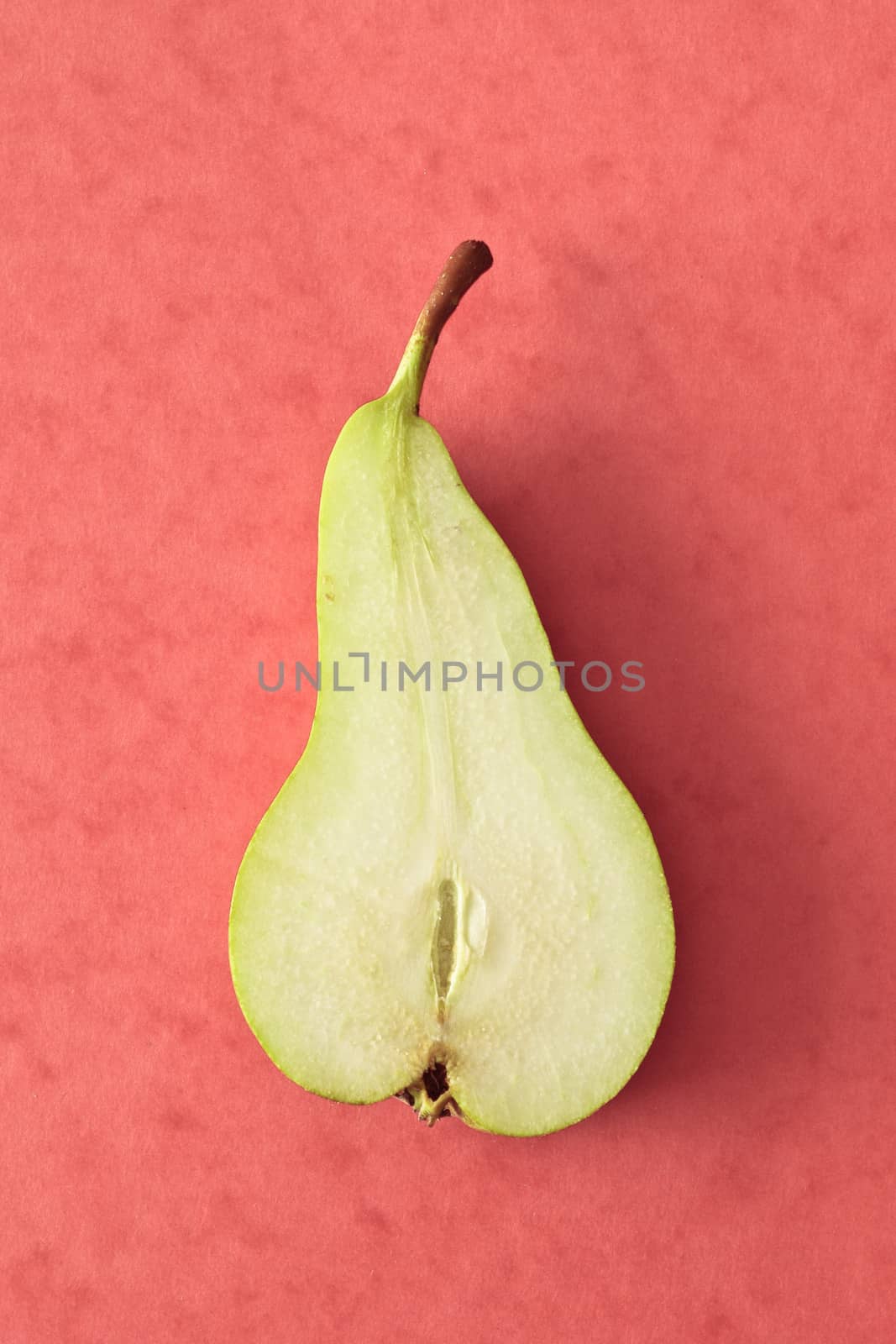 Slice of a pear  on a red background