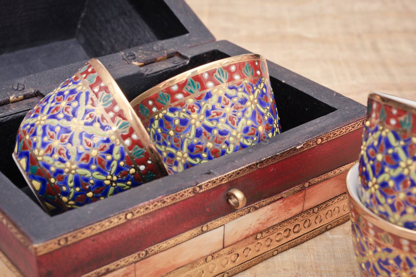 Traditional middle eastern tea cups in a wooden box