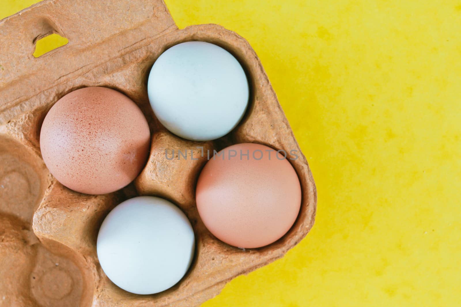 Box of eggs on a yellow background
