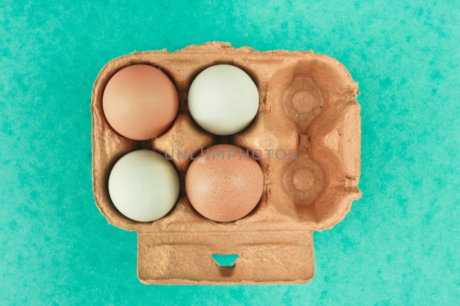 Box of eggs on a green background