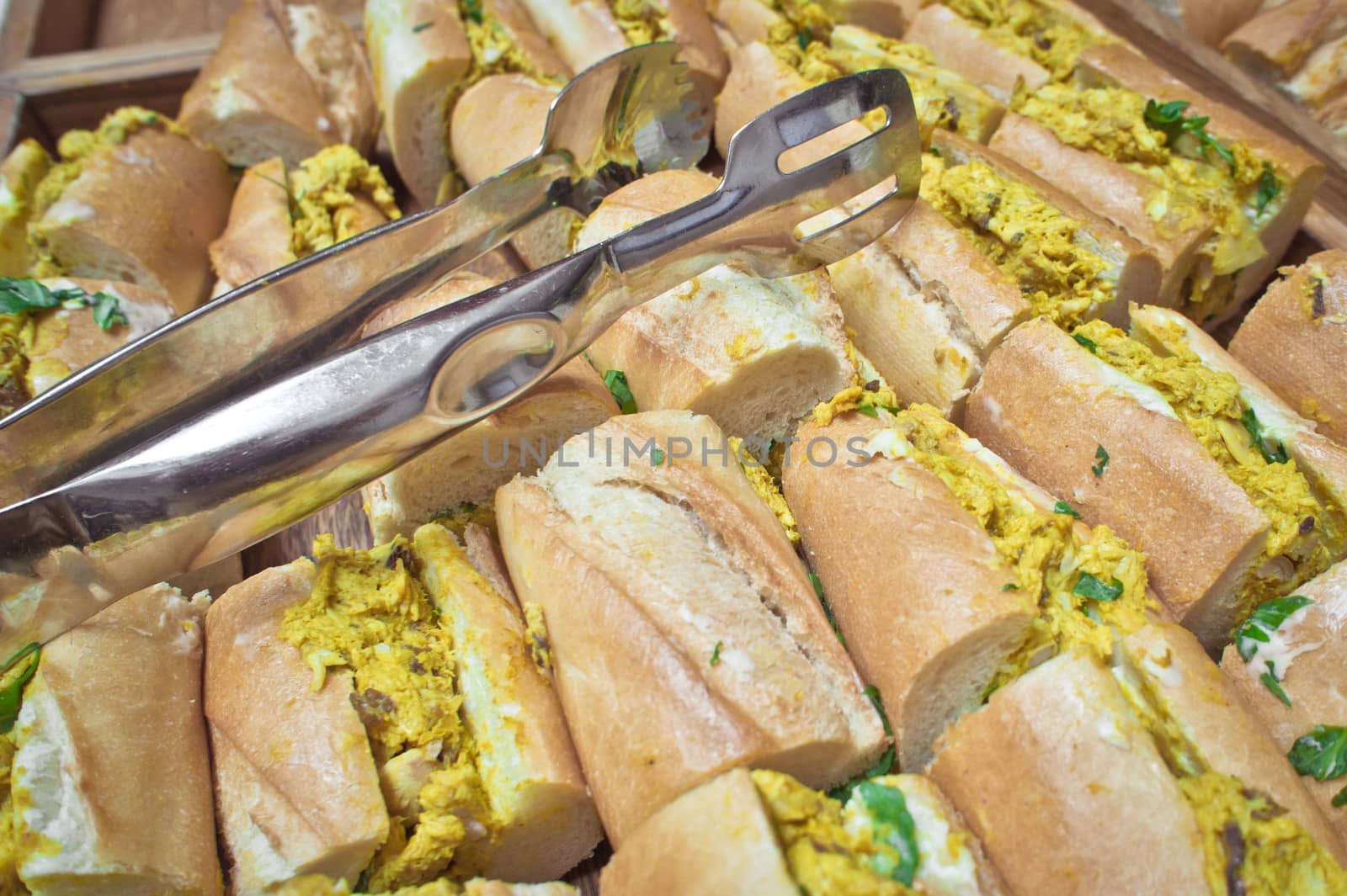 Freshly made corontaion chicken baguettes on a tray