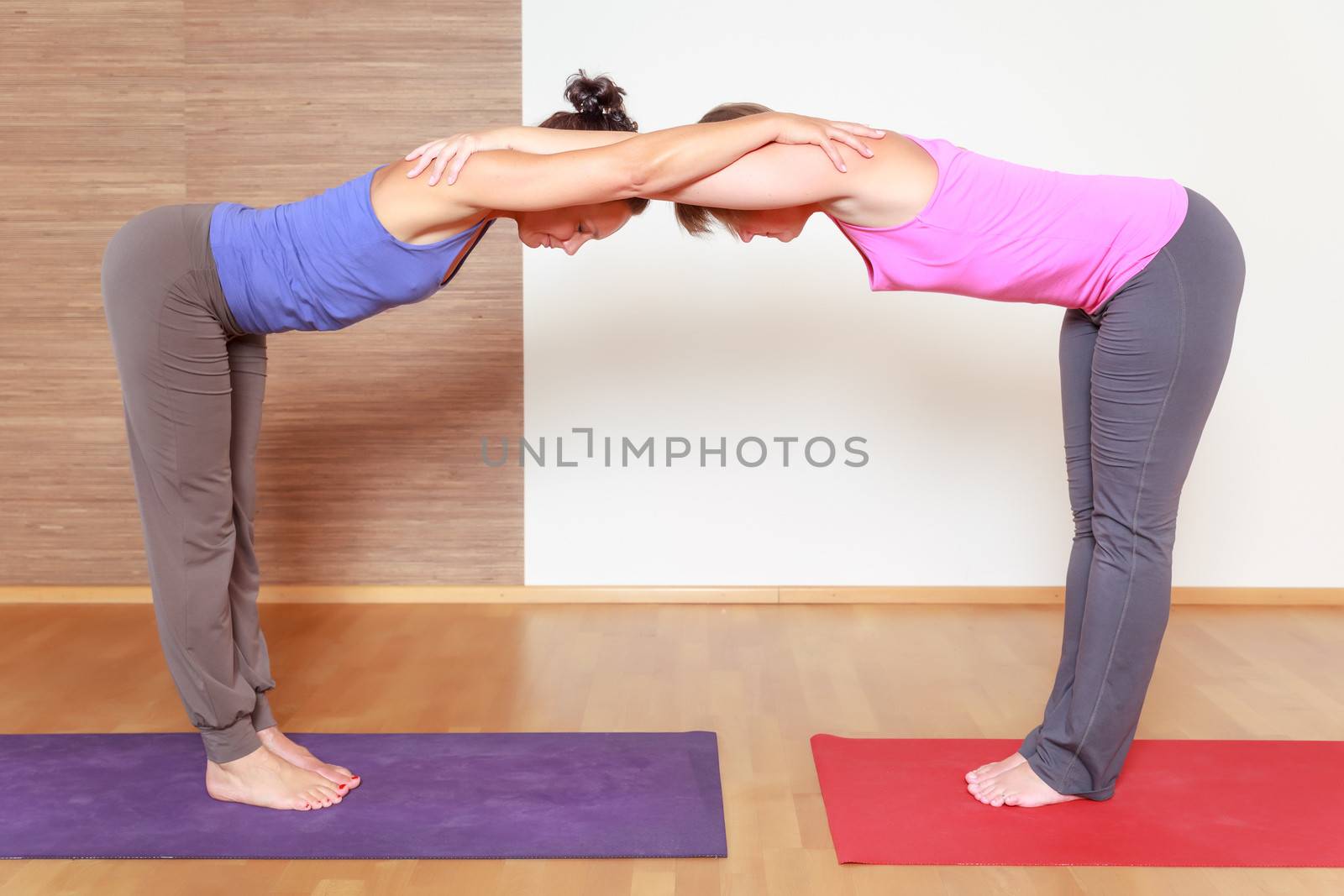 An image of some people doing yoga exercises