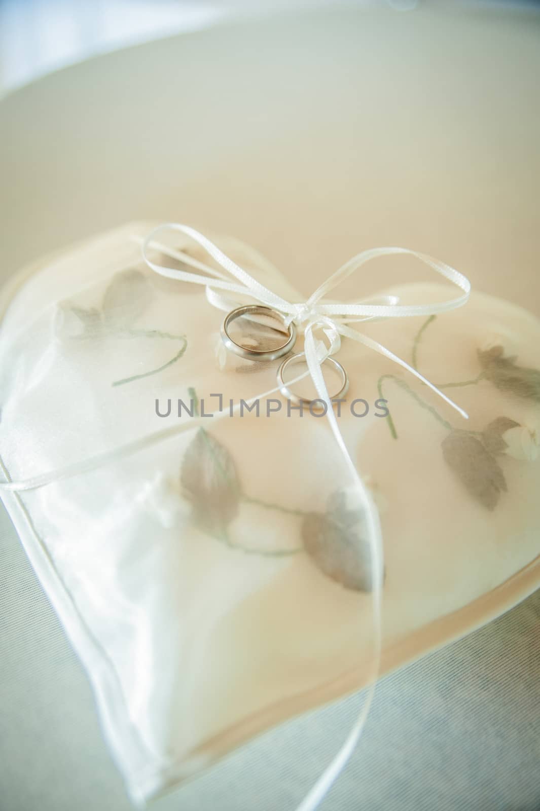 White Heart Shaped Pad with Wedding Rings