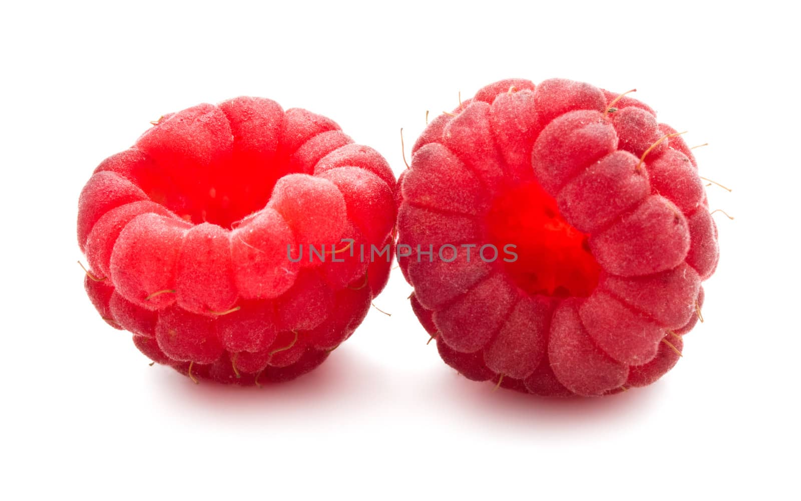 Ripe red raspberries isolated on white background