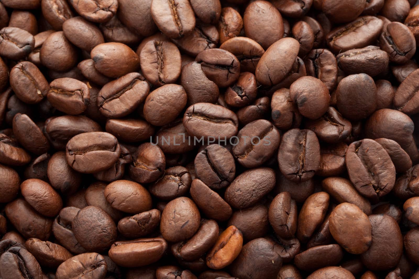 Close-up of brown coffee beans, background texture