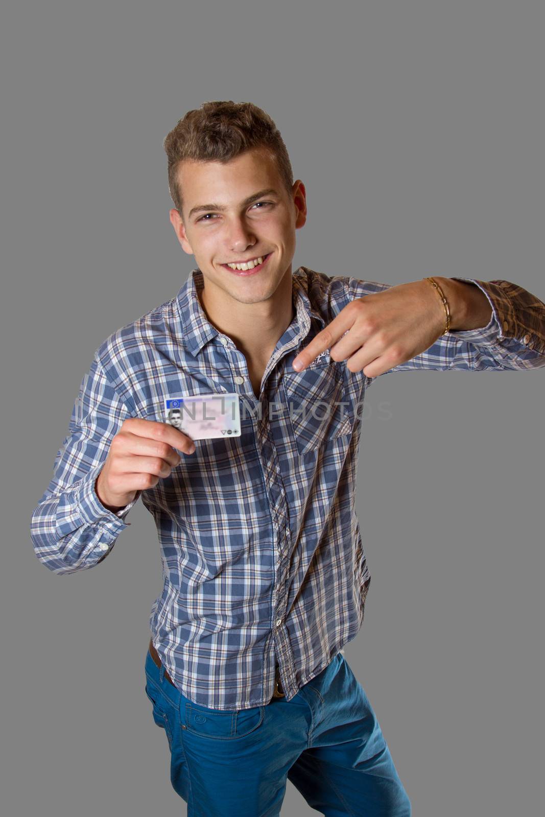 Young man showing off his driver license by Cursedsenses