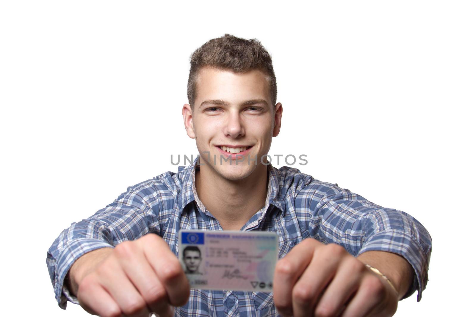 Young man just recieved his drivers license and is happy to drive his own car soon