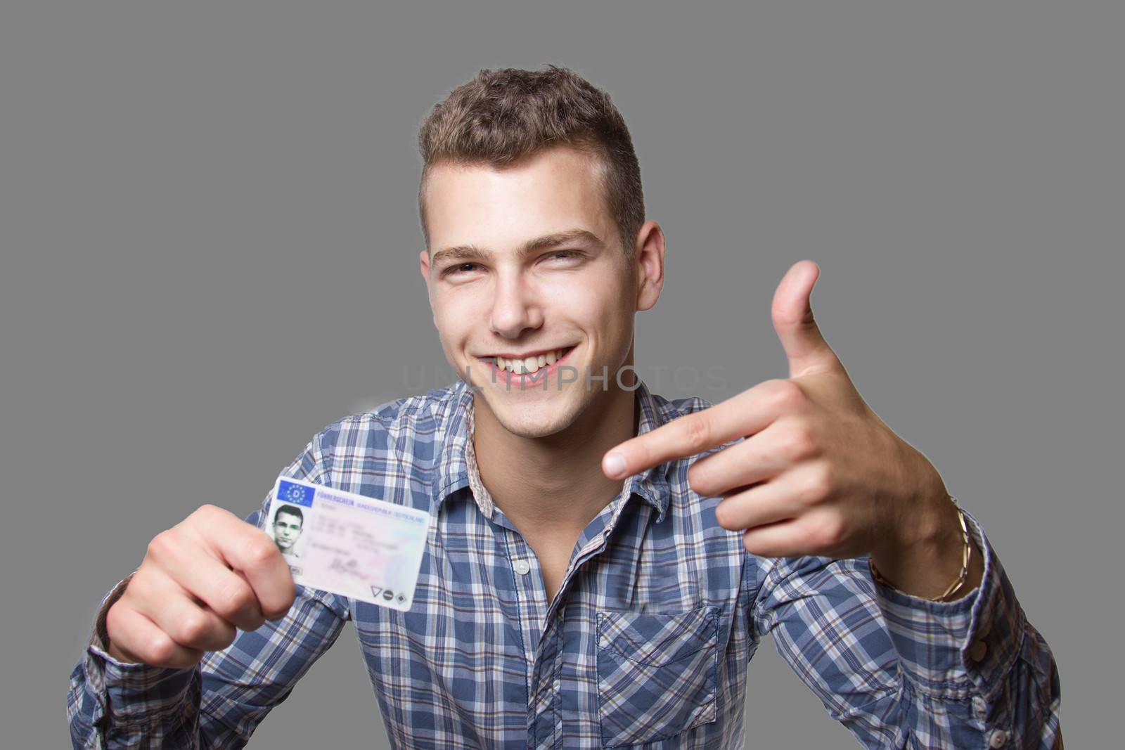 Young man showing off his driver license by Cursedsenses