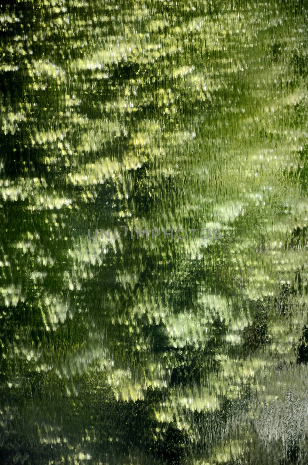 Abstract green reflected on mirror waterfall background