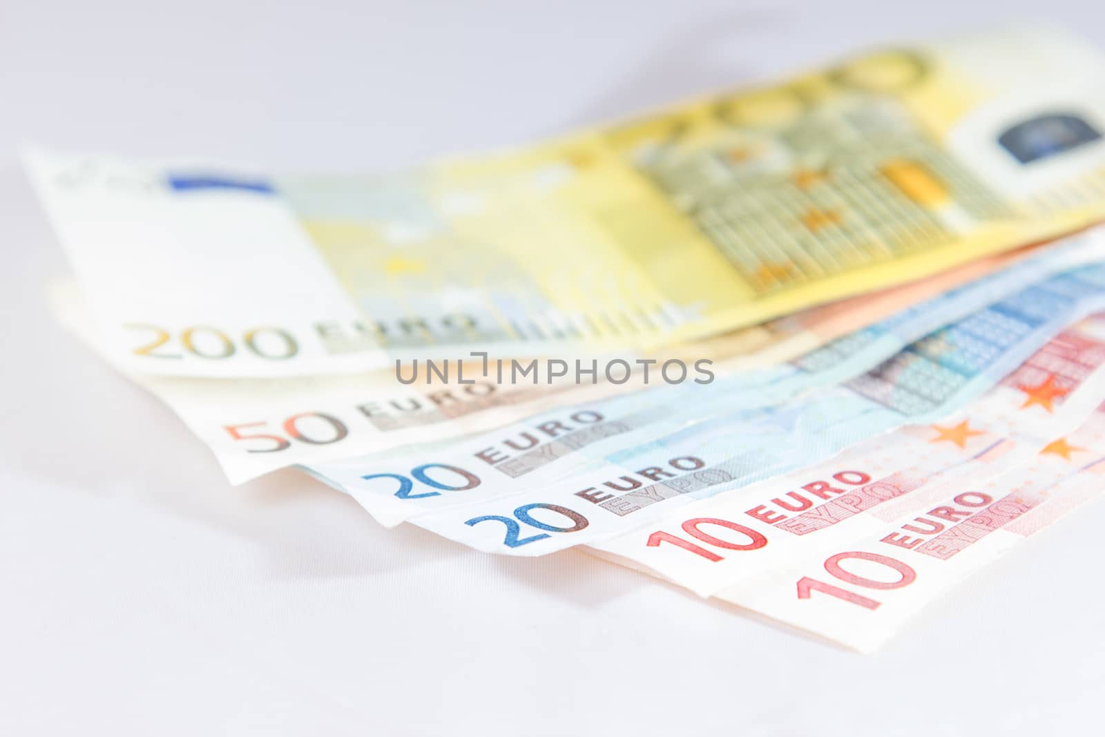 Euro notes lying on other notes with light white background