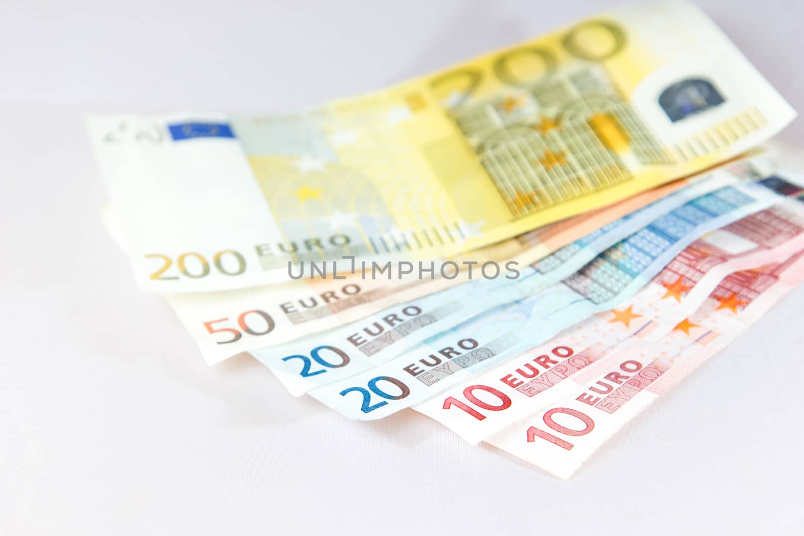 Euro notes lying on other notes with white background by Cursedsenses
