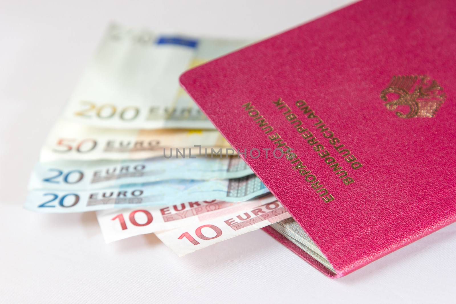 Several Euro-Notes lying in a german passport for traveling