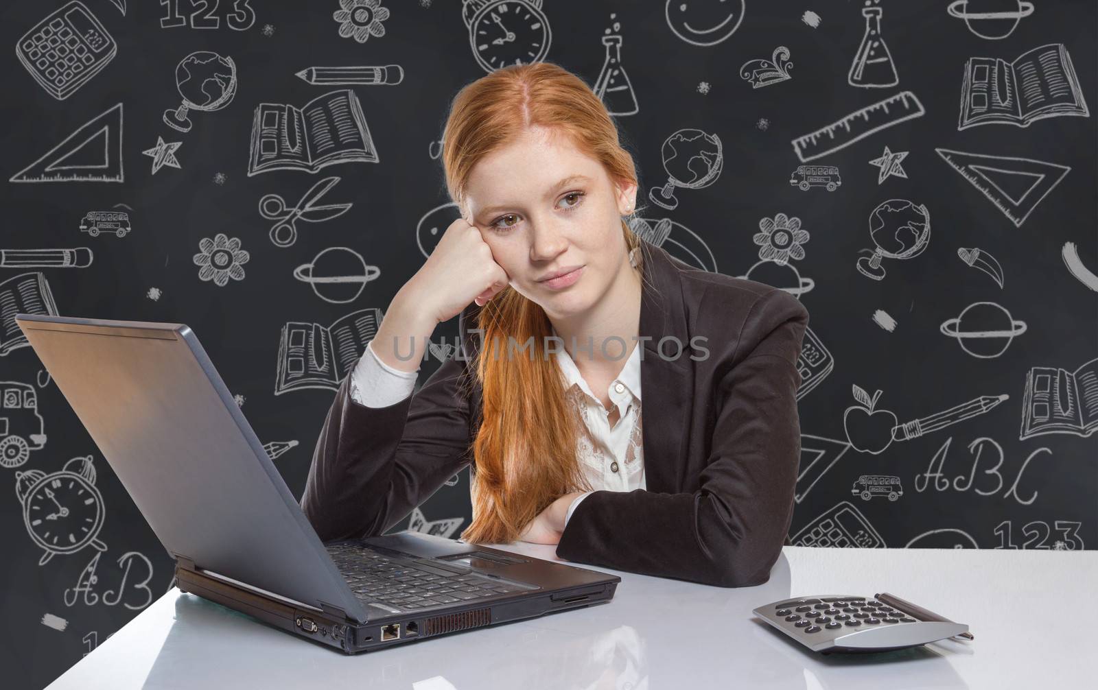 Young businesswoman sitting in front of her notebook by Cursedsenses