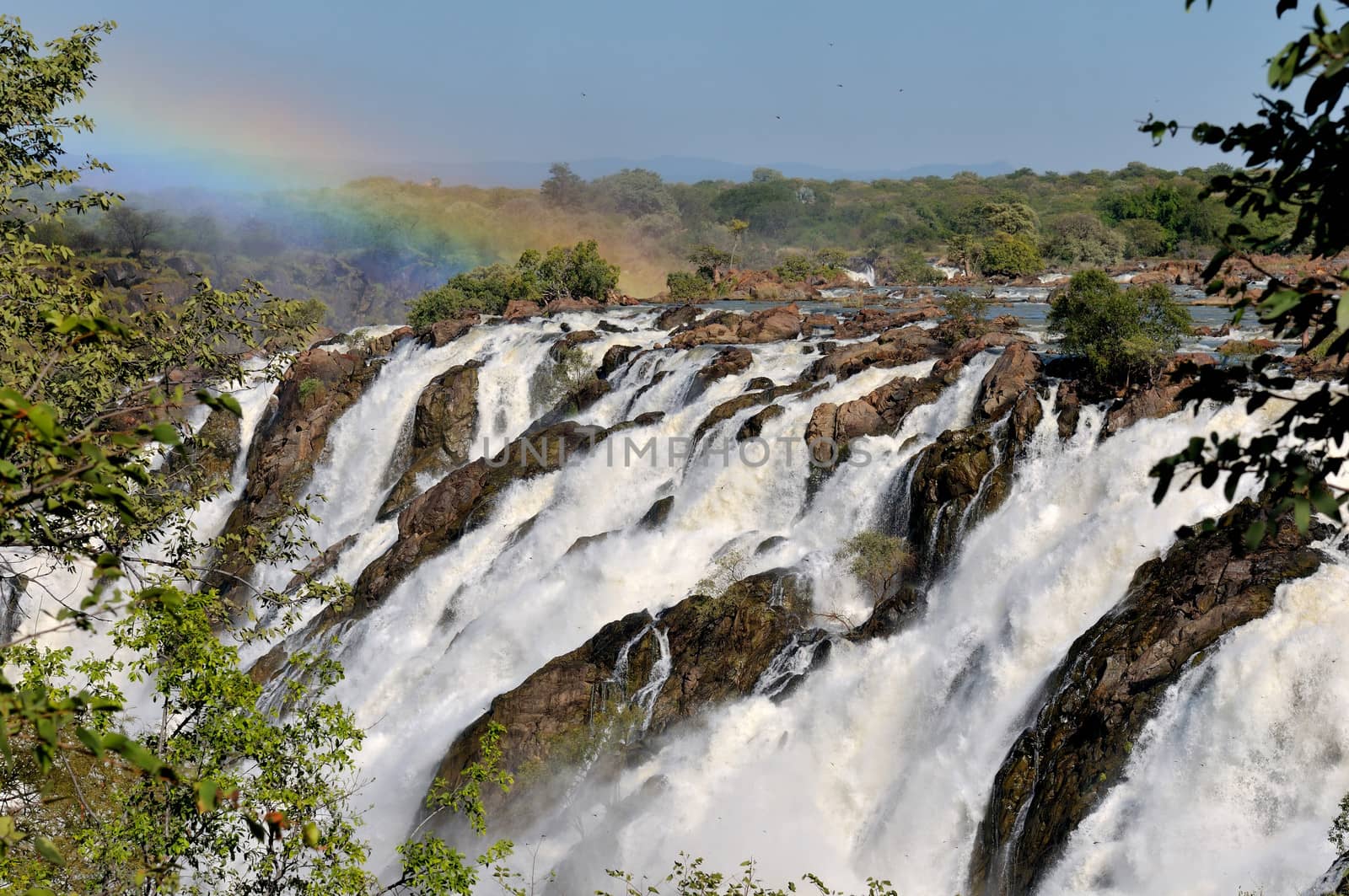 Ruacana waterfalls on the border of Namibia and Angola at sunrise, Dragon flies visible everywhere.