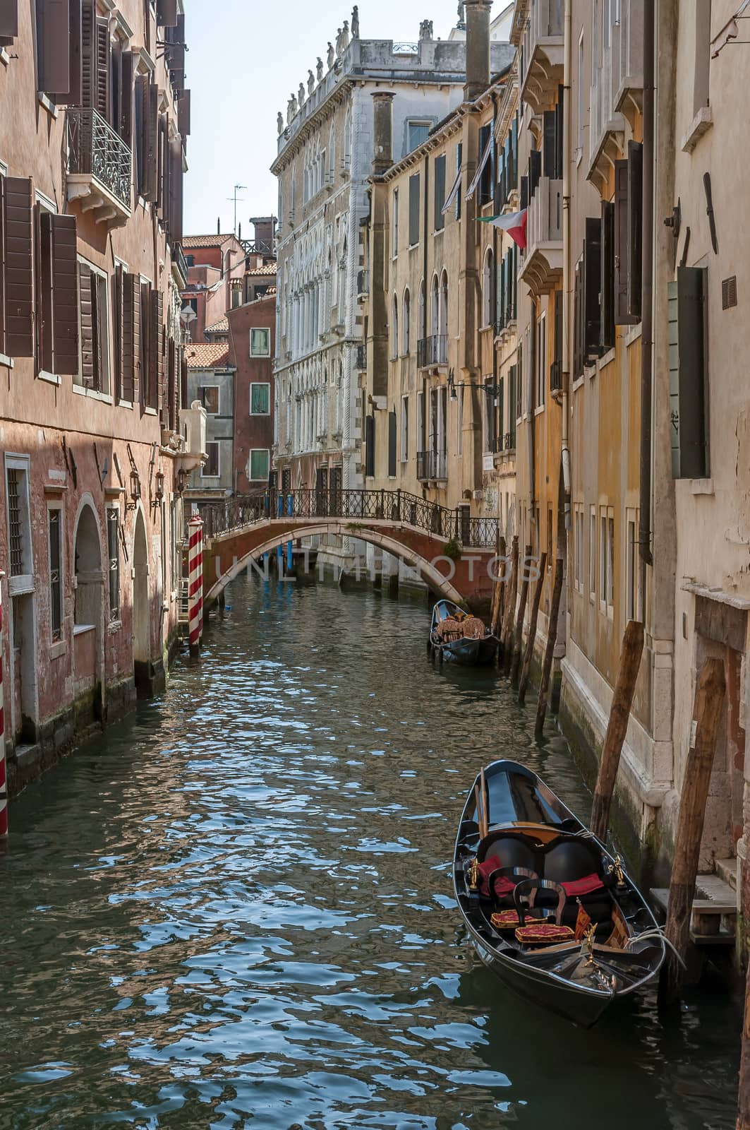 View of a canal, gondolas, and typical buildings in Venice, Italy.
