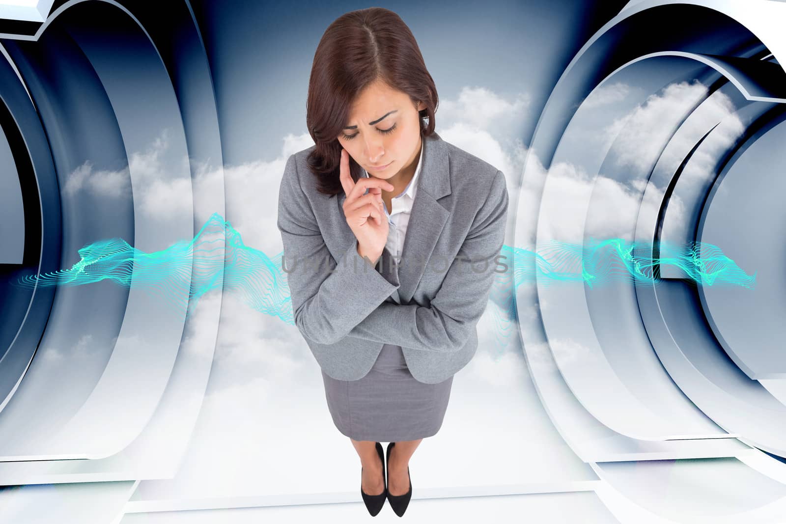 Worried businesswoman against abstract blue cloud design in futuristic structure