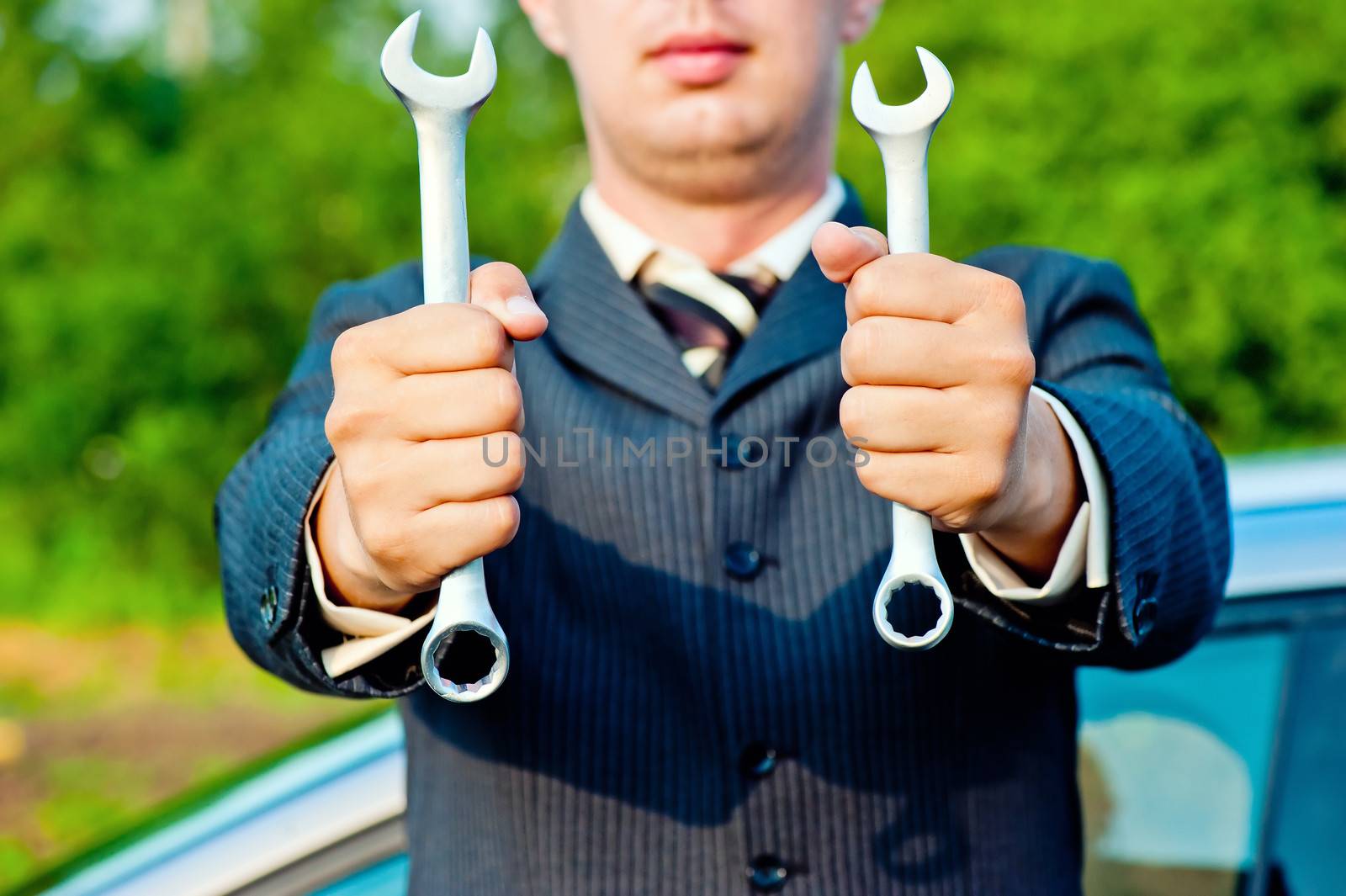 spanners in the hands of a businessman