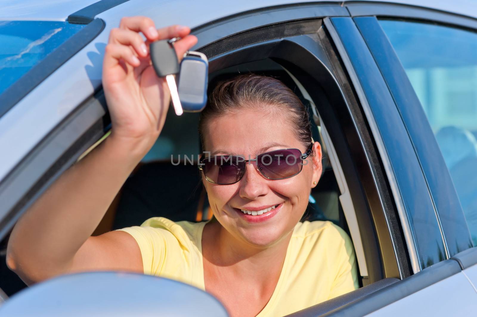 girl shows off the key to the new car