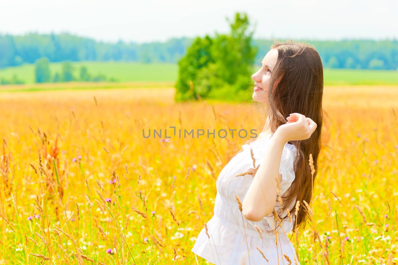 happy woman in a white sundress in the field by kosmsos111