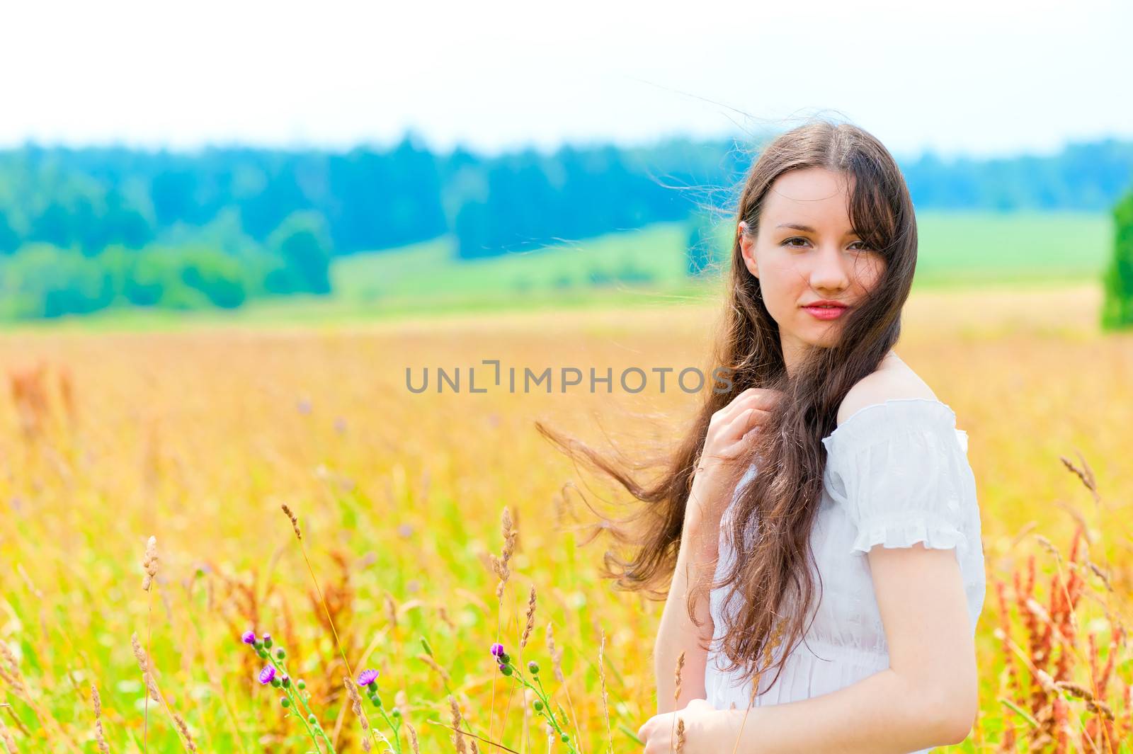 young beautiful woman with long hair in white in colors